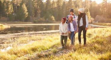 African American Family Walking By Lake