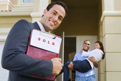 happy-realtor-couple-hold