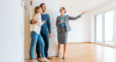 Realtor showing house to a young couple wanting to rent it